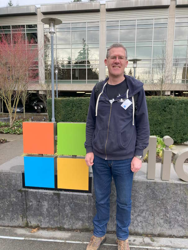 David standing in front of the Microsoft logo